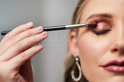 Buy stock photo Closeup shot of a beautiful young bride applying make-up while preparing for her wedding in her dressing room