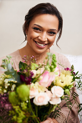 Buy stock photo Cropped portrait of a beautiful young bride holding a bouquet of flowers while sitting in her dressing room on the morning of  her wedding