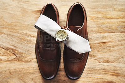 Buy stock photo Still life shot of a wristwatch and tie on top of formal shoes on a wooden surface