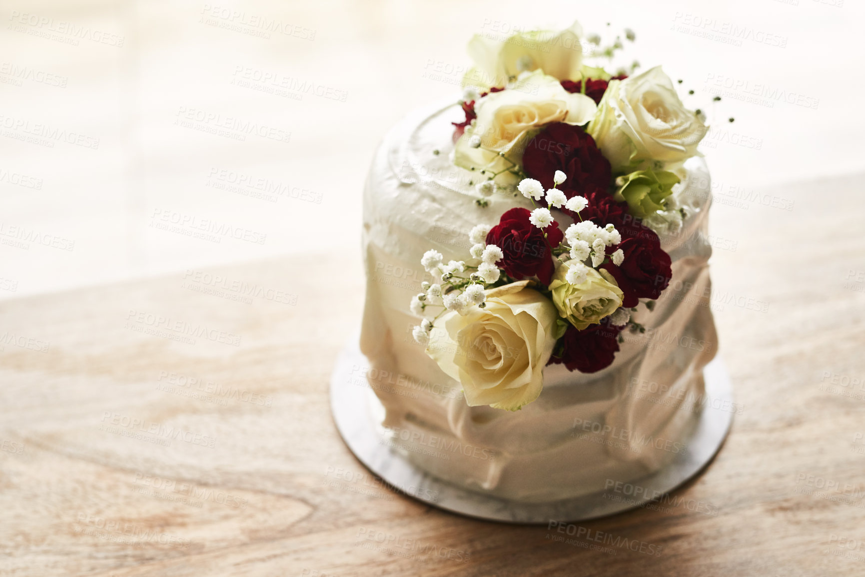 Buy stock photo Still life shot of a beautiful wedding cake on top of a wooden surface