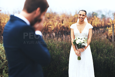 Buy stock photo Shot of a bridegroom crying while looking at his beautiful bride on their wedding day