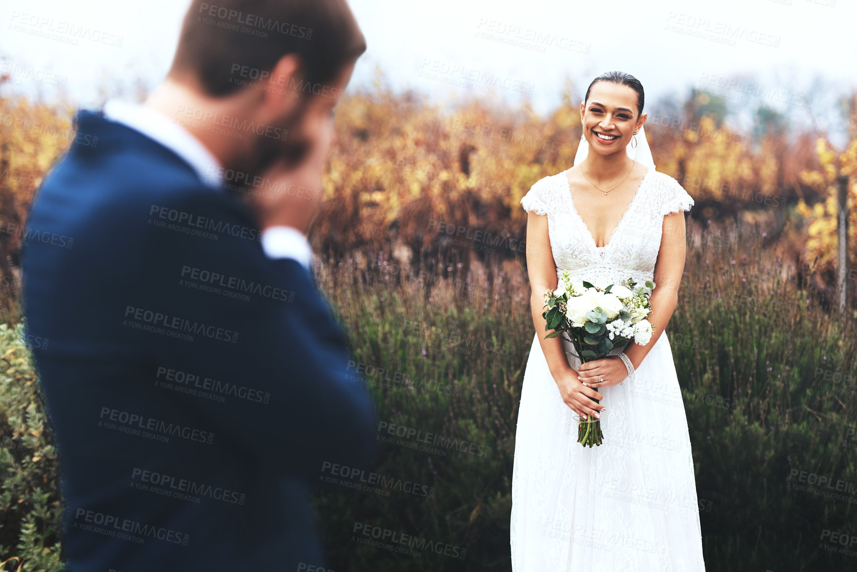 Buy stock photo Shot of a bridegroom crying while looking at his beautiful bride on their wedding day