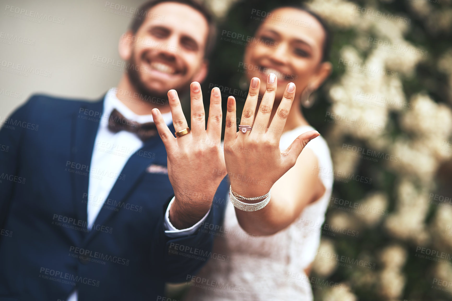 Buy stock photo Shot of a happy newlywed young couple showing their rings on their wedding day