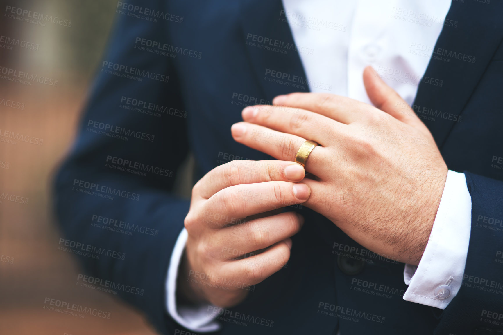 Buy stock photo Cropped shot of an unrecognizable bridegroom adjusting his ring on his wedding day