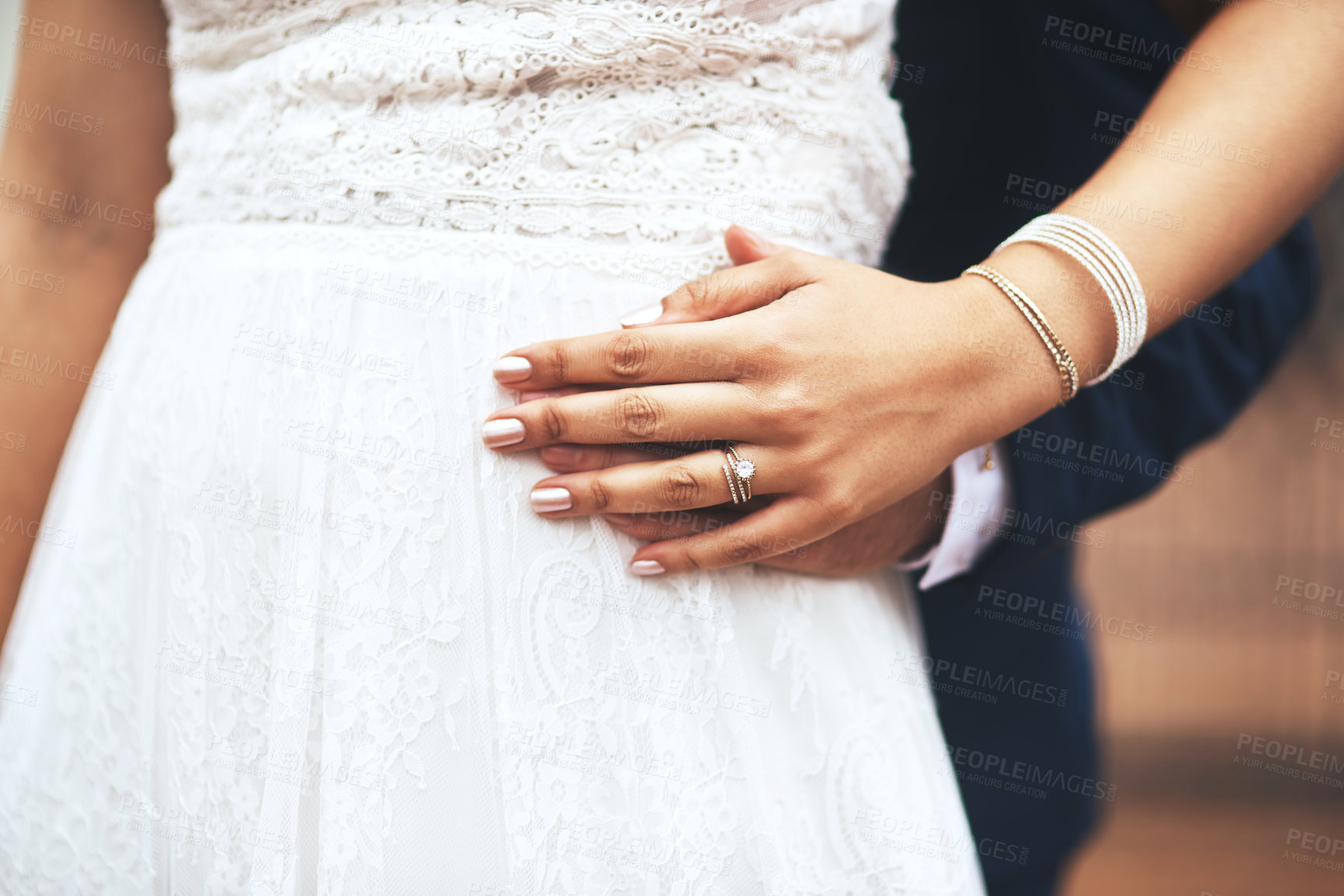 Buy stock photo Cropped shot of an unrecognizable newlywed couple holding hands on their wedding day