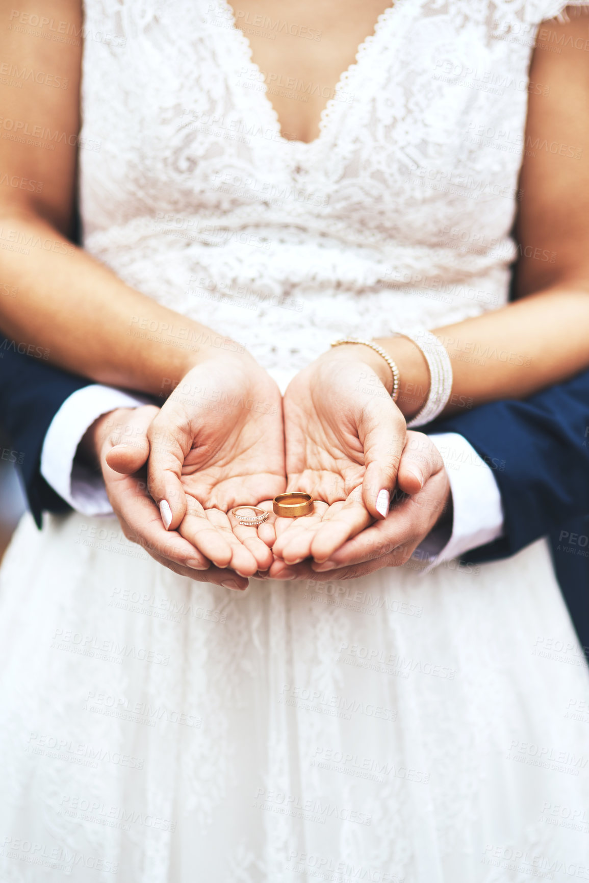 Buy stock photo Cropped shot of an unrecognizable newlywed couple holding and showing their rings on their wedding day
