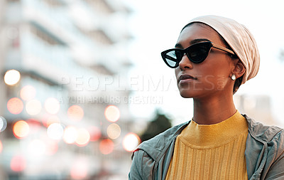 Buy stock photo Cropped shot of an attractive young woman wearing a hijab and sunglasses while touring the city