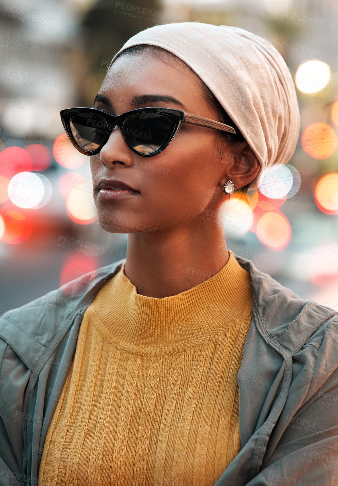 Buy stock photo Cropped shot of an attractive young woman wearing a hijab and sunglasses while touring the city