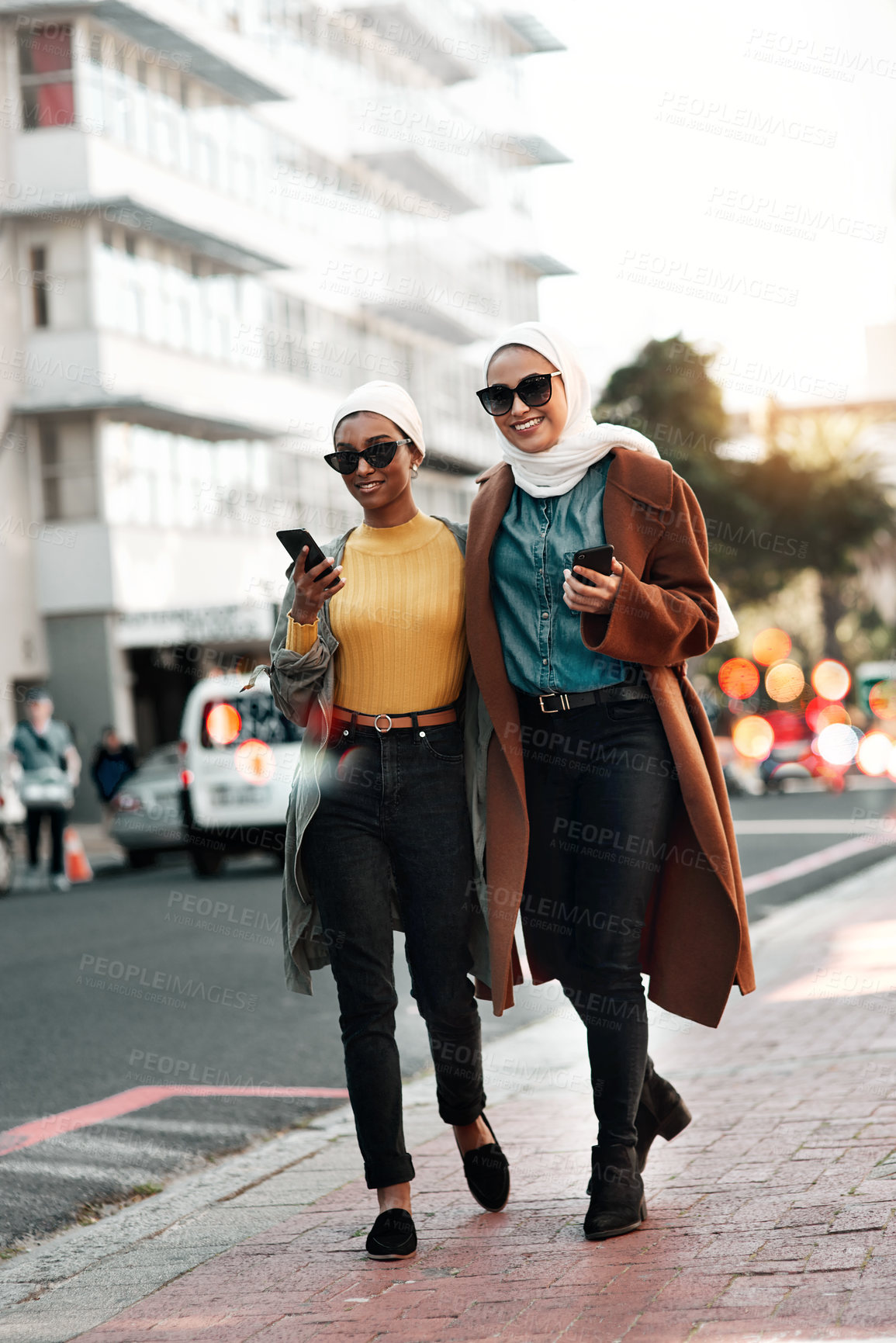 Buy stock photo City, muslim and phone with woman friends walking on sidewalk together outdoor for communication. App, smile and social media with happy Islamic people in urban town for contact, travel or shopping