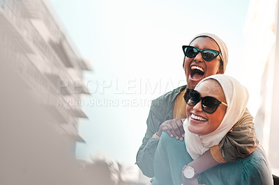 Buy stock photo Muslim women, friends and piggyback in city with mockup space, travel and comic adventure together. Islamic woman, happiness and walking in metro cbd with funny game, sunglasses and bond on journey