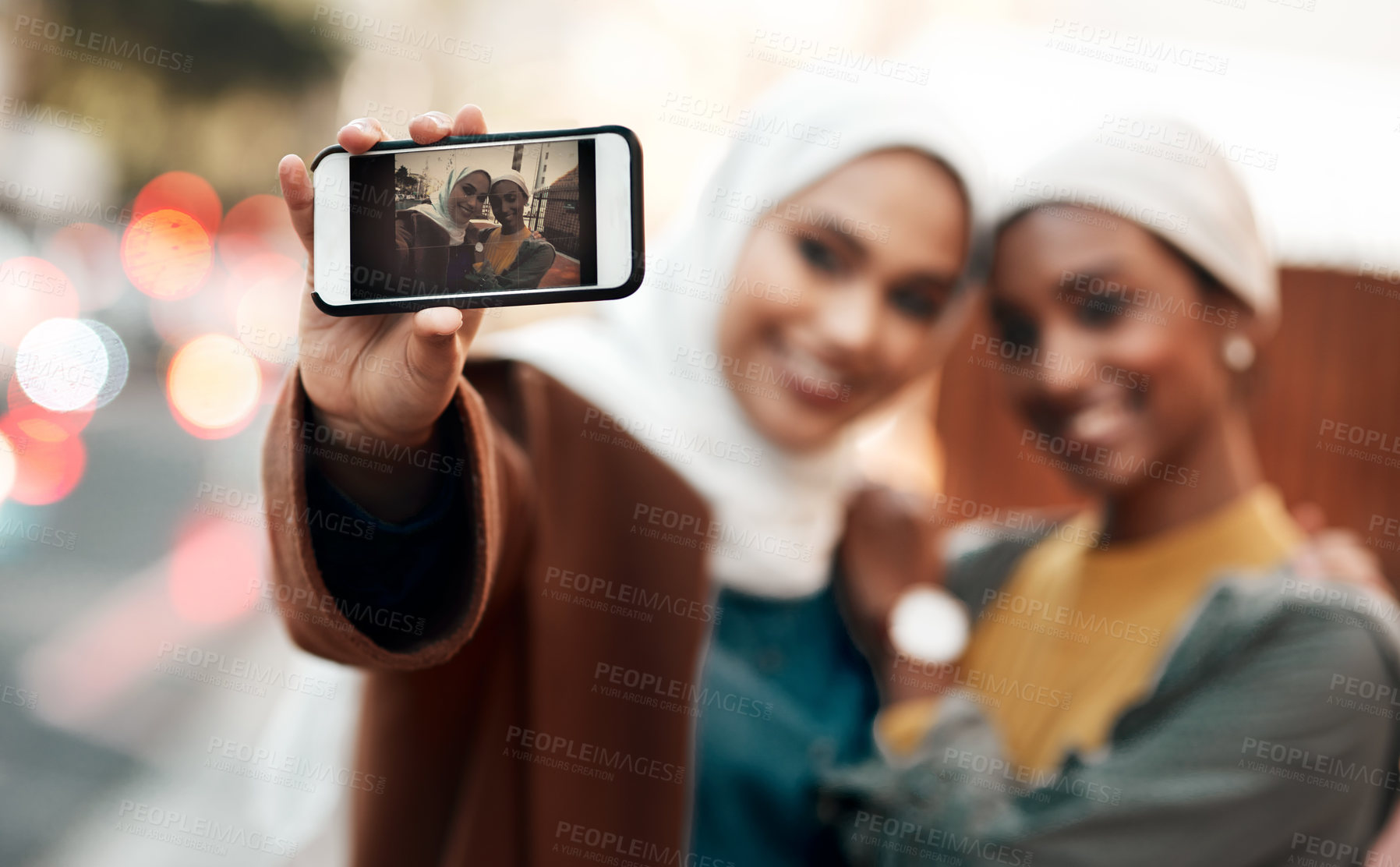 Buy stock photo Muslim woman, friends and selfie with phone in city for travel, urban adventure or post for social media app. Islamic women, smartphone photography and profile picture on internet, web or blog in cbd