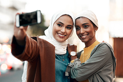 Buy stock photo Muslim woman, selfie and social media in city together with happiness, outdoor or urban adventure. Islamic women, profile picture and photography for travel blog, app and friends on road in metro cbd