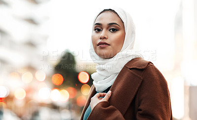 Buy stock photo Cropped shot of an attractive young woman wearing a hijab and standing alone while touring the city
