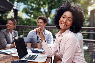 Buy stock photo Cropped portrait of an attractive young businesswoman sitting with her colleagues during a meeting outside the office