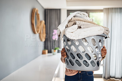 Buy stock photo Cropped shot of a woman carrying a laundry basket full of washing at home