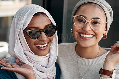Buy stock photo Cropped portrait of two affectionate young girlfriends hanging out together at a cafe while dressed in hijab