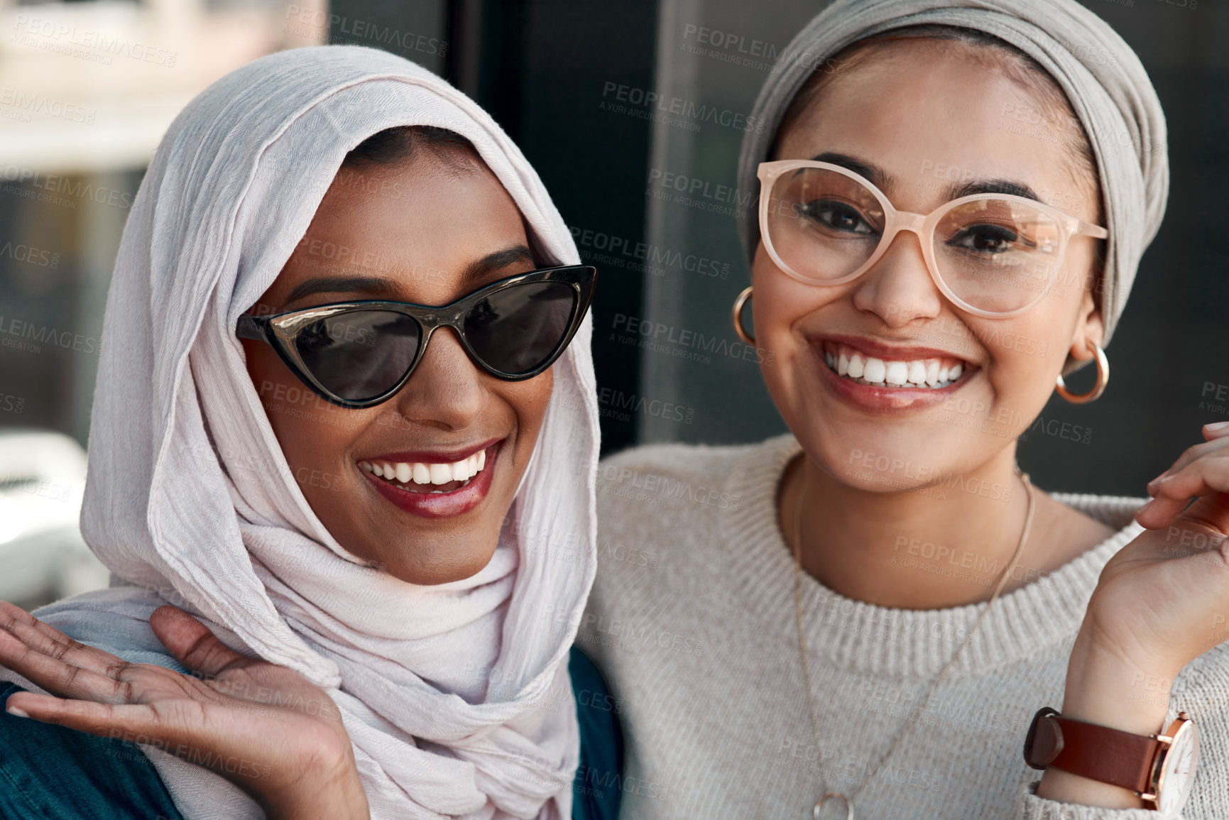 Buy stock photo Cropped portrait of two affectionate young girlfriends hanging out together at a cafe while dressed in hijab