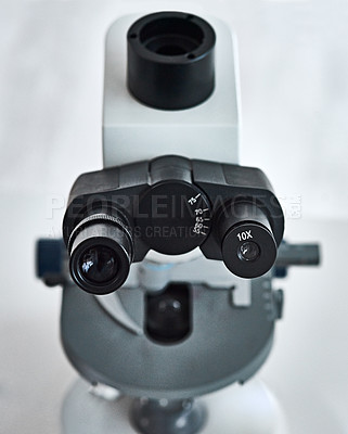 Buy stock photo Still life shot of a microscope placed in a laboratory
