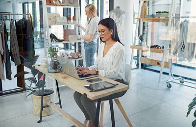 Buy stock photo Shot of a young business owner using a laptop in her store