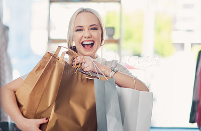 Buy stock photo Shot of an attractive young woman carrying shopping bags