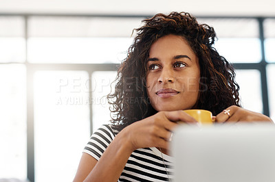 Buy stock photo Cropped shot of an attractive young businesswoman sitting and looking contemplative while holding a cup of coffee in her home