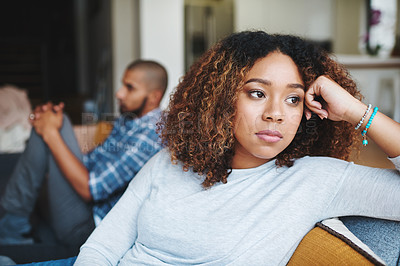 Buy stock photo Unhappy couple and sad woman upset after argument or conflict with her man on home sofa. Angry girlfriend or female thinking about disagreement or ignoring partner, tired of relationship problems.