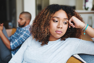 Buy stock photo Cropped shot of an attractive young woman looking upset after an argument with her husband in their home