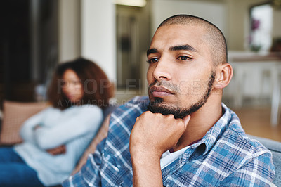Buy stock photo Unhappy couple after argument with a frustrated, upset and sad husband looking away from his wife at home. Depressed and distant boyfriend sitting on the couch after fighting with his girlfriend 