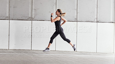 Buy stock photo Portrait of a sporty young woman running outdoors