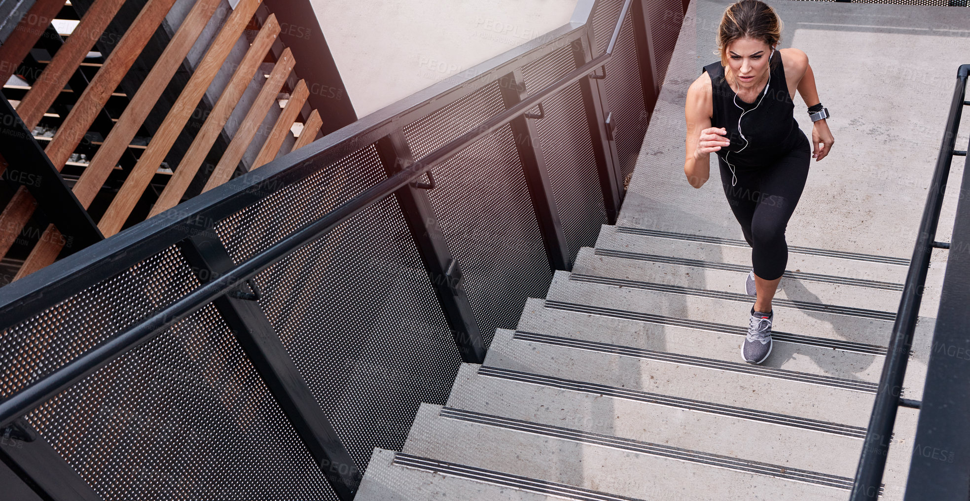Buy stock photo High angle shot of a sporty young woman running up a staircase outdoors