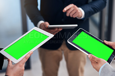 Buy stock photo Cropped shot of a group of businesspeople using their digital tablets during a collaboration