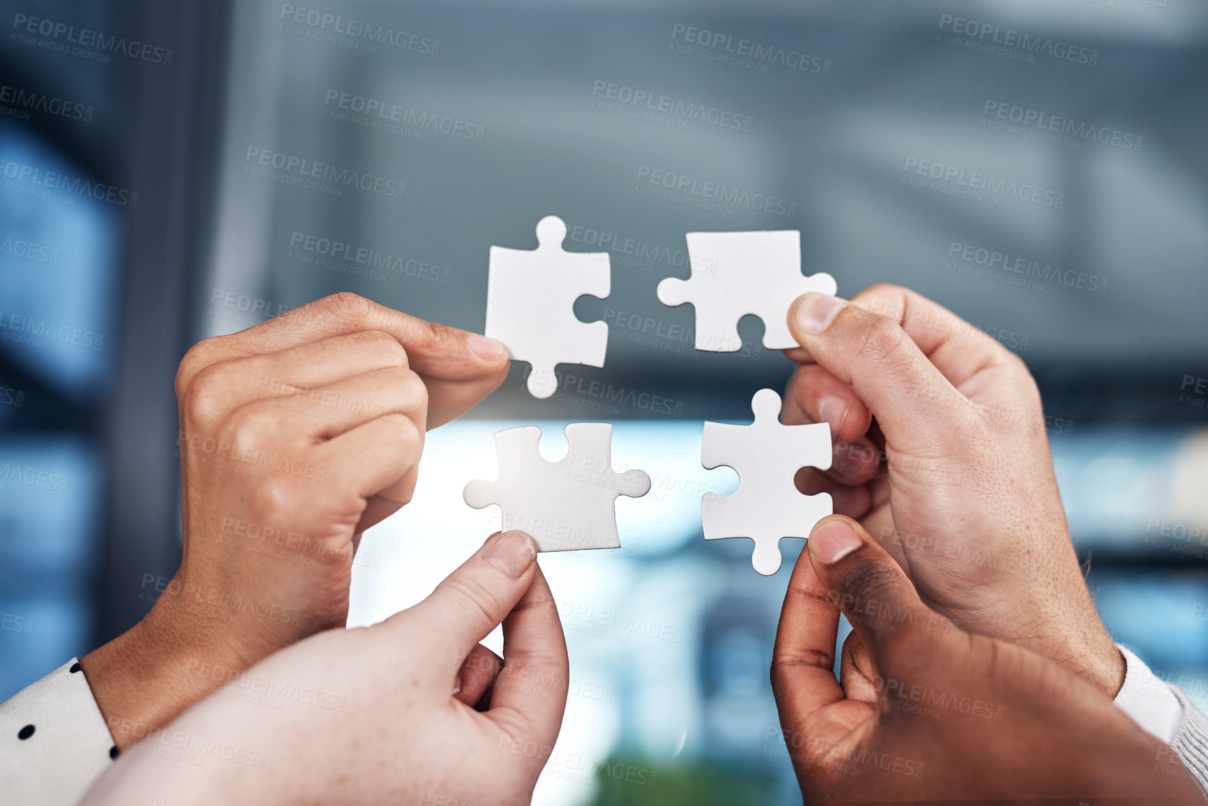 Buy stock photo Cropped shot of a group of businesspeople completing a puzzle