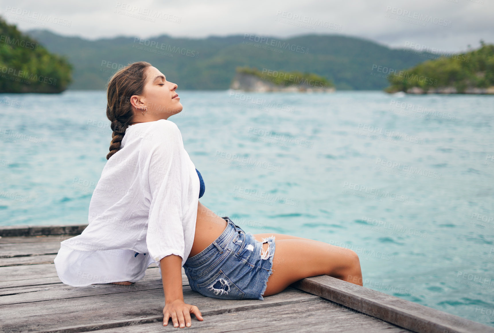 Buy stock photo Island, ocean and woman relax on deck for holiday, summer vacation and weekend getaway in Maldives. Traveling, tropical beach and calm female person on luxury resort for tourism, happiness or freedom