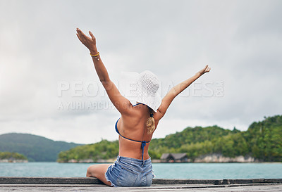 Buy stock photo Island, ocean and happy woman relax on deck for holiday, summer vacation and weekend getaway in Maldives. Luxury resort, tropical beach and female person with arms up for tourism, sea and adventure