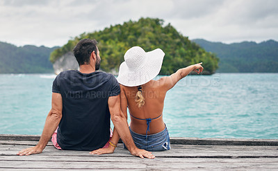 Buy stock photo Ocean, vacation and couple together on deck, dock or sitting on boardwalk to relax and enjoy the sea, water or landscape. People, man and woman on holiday, summer travel or tropical date in Bali