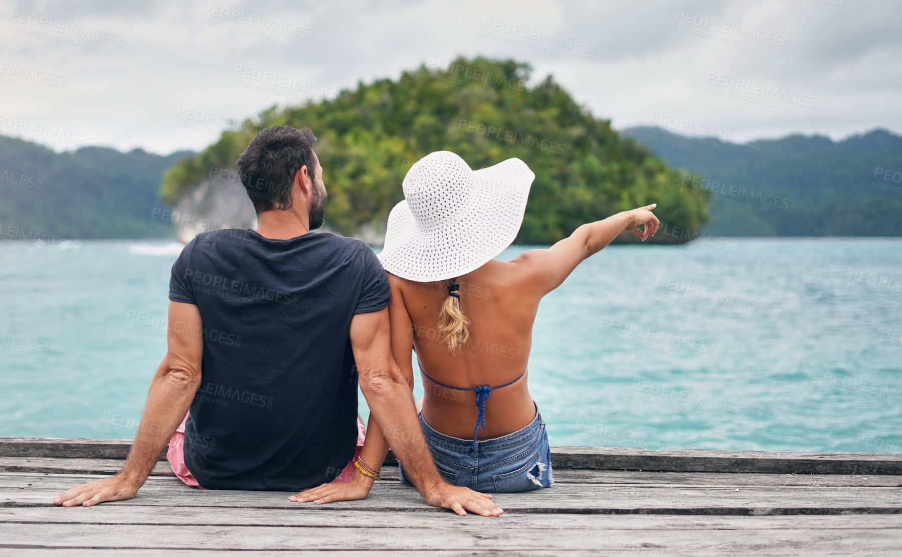 Buy stock photo Ocean, vacation and couple together on deck, dock or sitting on boardwalk to relax and enjoy the sea, water or landscape. People, man and woman on holiday, summer travel or tropical date in Bali