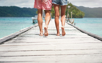 Buy stock photo Couple, feet and ocean pier on a island on vacation with walking freedom by sea. Travel, tropical beach and deck walk of a man back and woman together with love in summer on a holiday outdoor in sun