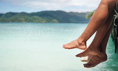 Buy stock photo People, legs and lake while sitting for vacation, travel and summer outdoor in nature with calm. Couple, feet and beach on dock for holiday, peace and relax with water, sky and mountain in background