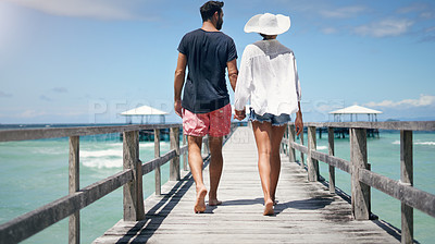 Buy stock photo Couple, walking and Maldives pier on a tropical island on vacation with freedom by sea. Ocean, beach and deck walk of man back and woman together with love in summer on a holiday outdoor in sun