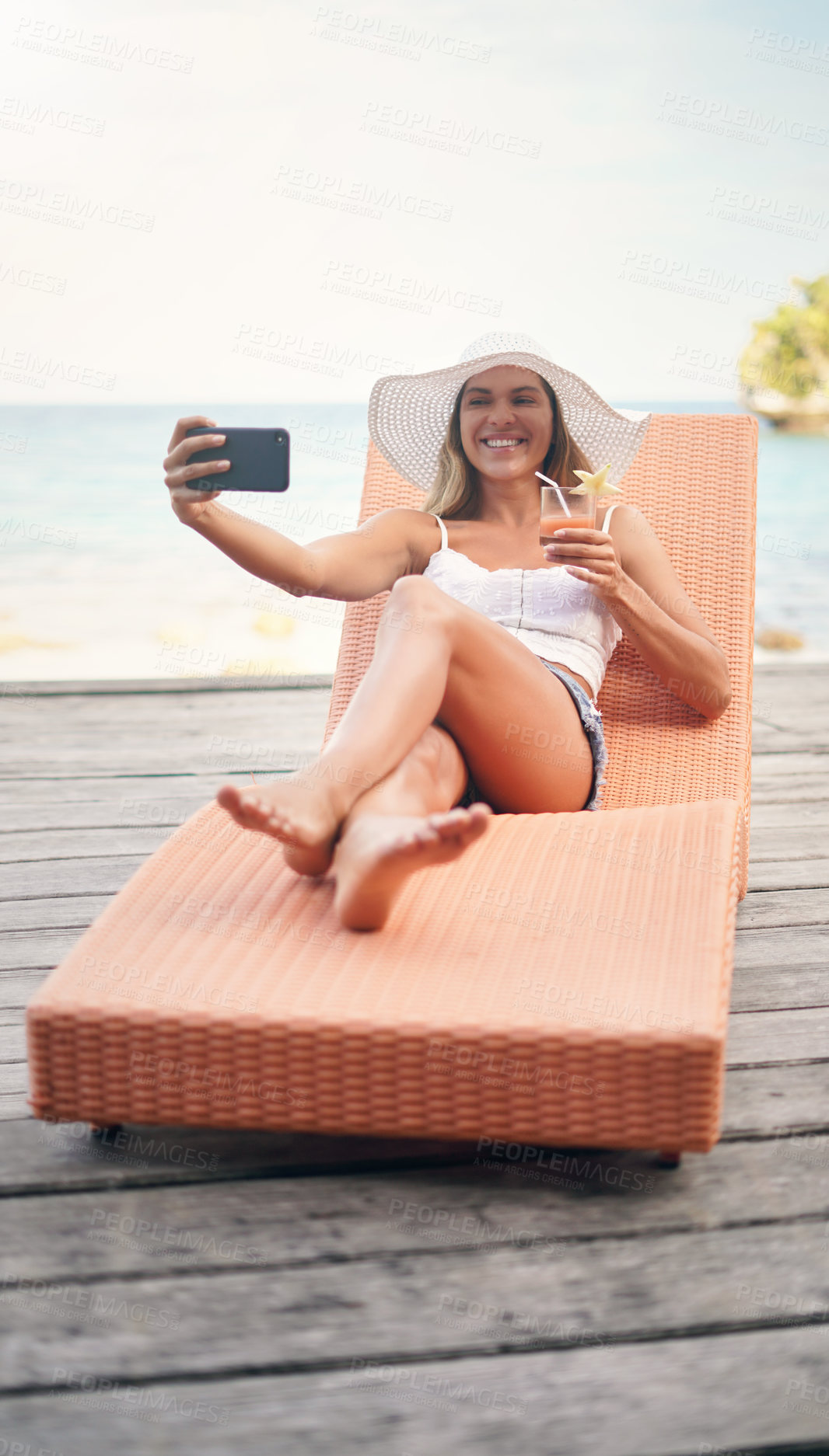 Buy stock photo Woman, lounge selfie and cocktail on tropical holiday by the ocean on deck chair with a smile. Female person, travel and Maldives island in summer taking a photo for profile picture and social media