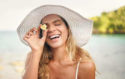 Buy stock photo Ocean, woman and smile with pineapple by face on holiday for tropical vacation, diet and trip. Happy, summer and person with fruit in heart shape at beach for health, nutrition and travel in Greece