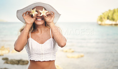 Buy stock photo Cropped shot of an attractive young woman standing and playfully holding up star shaped pineapple pieces against her eyes