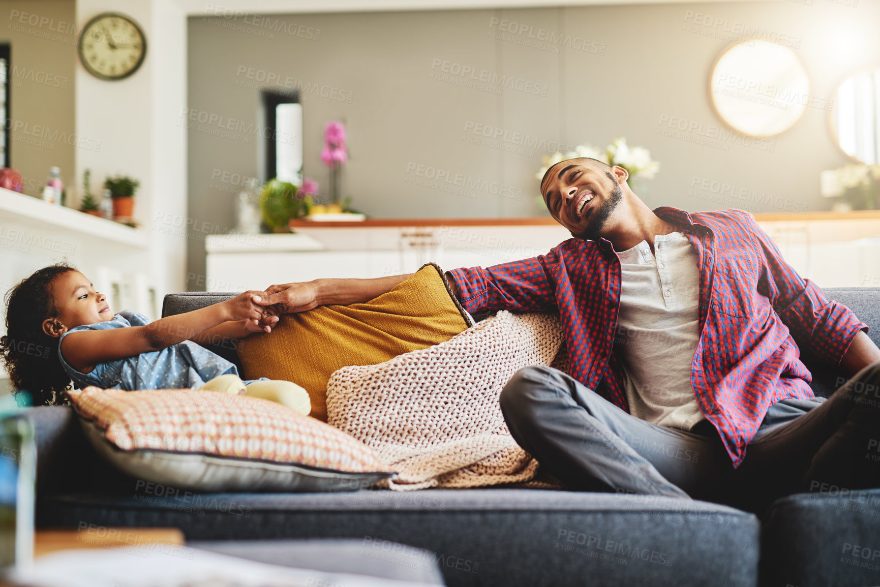 Buy stock photo Cropped shot of an adorable little girl pulling her father's hand playfully in their living room at home