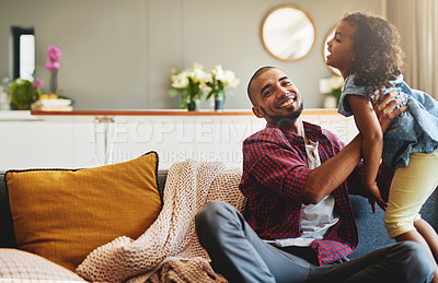 Buy stock photo Cropped shot of an affectionate young father lifting his daughter playfully in their living room at home