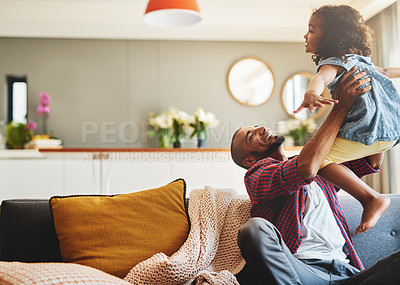 Buy stock photo Cropped shot of an affectionate young father lifting his daughter playfully in their living room at home