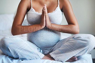 Buy stock photo Cropped shot of an unrecognizable pregnant woman practicing yoga inside her bedroom at home