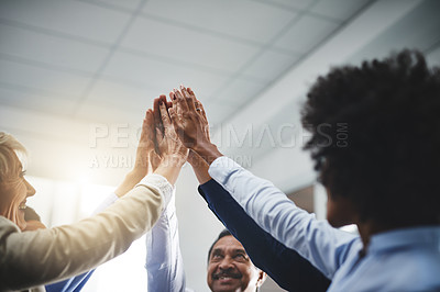 Buy stock photo Cropped shot of a diverse group of businesspeople giving each other a high five after a meeting in the office