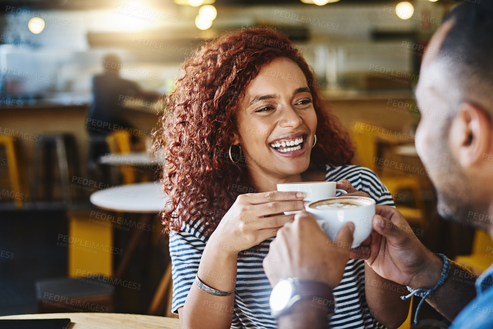 Buy stock photo Cropped shot of a happy young couple sitting together in a cafe and enjoy a coffee during a date