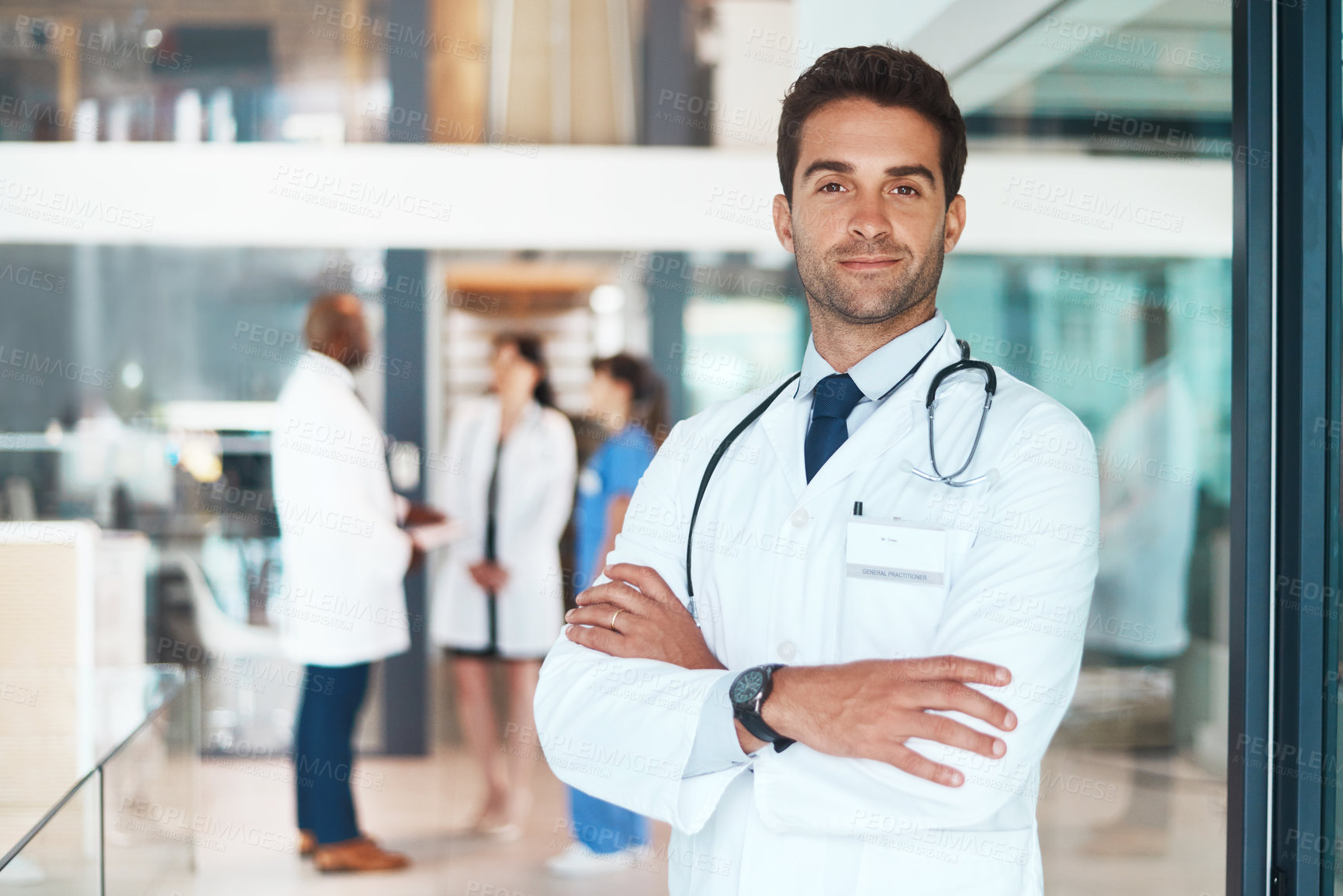 Buy stock photo Doctor, portrait and crossed arms in hospital for healthcare, wellness or medical experience with stethoscope. Man, smile and surgeon in health facility with confidence for cardiology or medicine