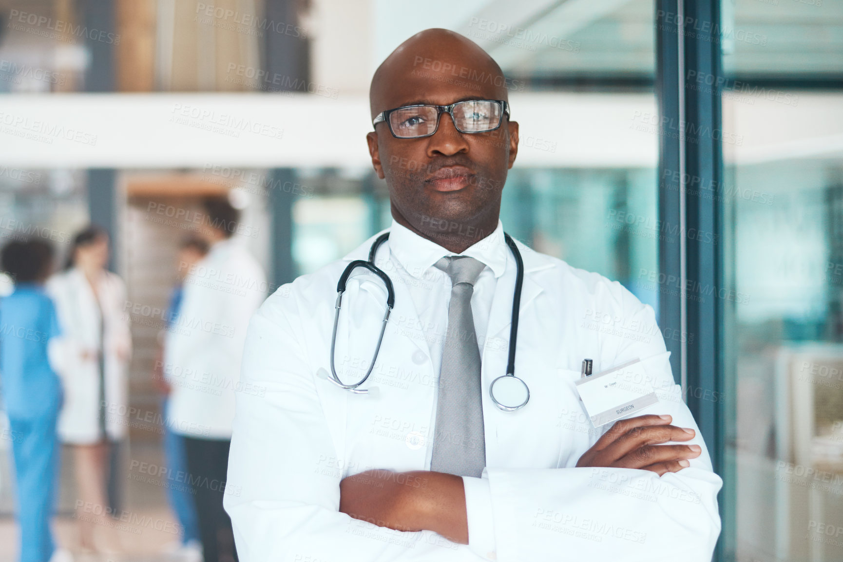 Buy stock photo Doctor, glasses and confidence in hospital for healthcare, wellness or medical experience with stethoscope. Black man, portrait and face in clinic with crossed arms for cardiology, health or medicine